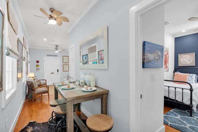 hallway featuring ornamental molding, recessed lighting, and wood finished floors