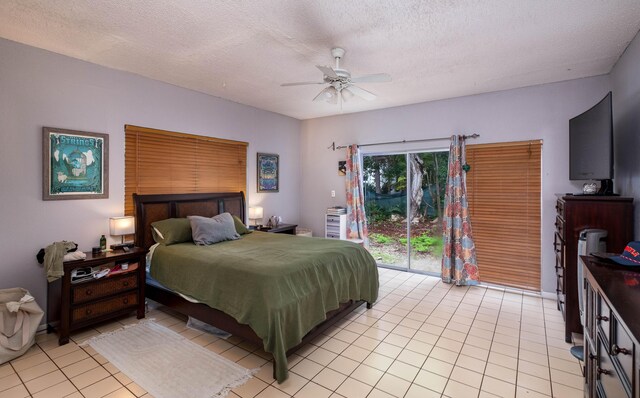 tiled bedroom with ceiling fan, access to outside, and a textured ceiling