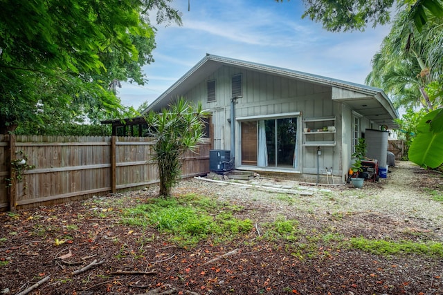 rear view of property featuring central AC unit