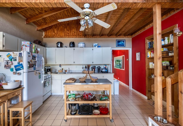 kitchen with vaulted ceiling with beams, white cabinets, light tile patterned floors, wooden ceiling, and white appliances