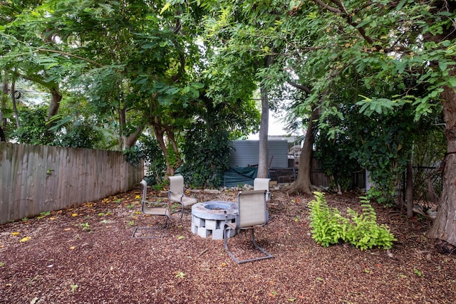 view of yard with a fire pit