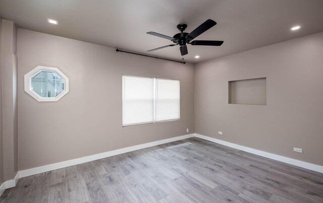 spare room with ceiling fan and light hardwood / wood-style floors