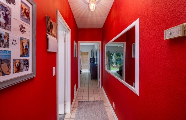 corridor featuring light tile patterned floors