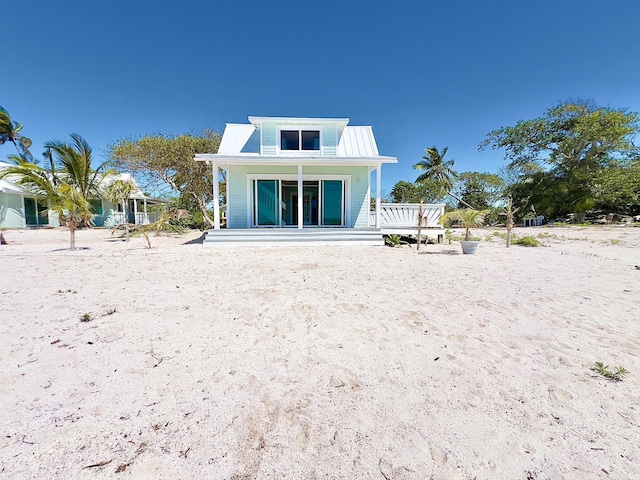 rear view of property featuring a porch