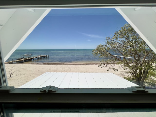 exterior space featuring a beach view and a water view