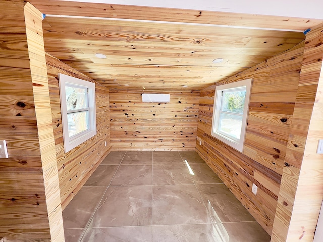 additional living space with vaulted ceiling, wooden ceiling, and wooden walls