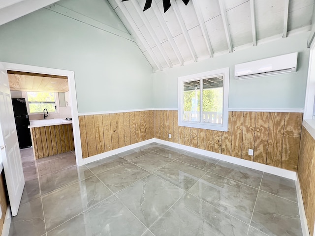 spare room with plenty of natural light, wooden walls, beam ceiling, and a wall unit AC