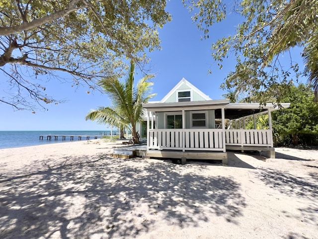 view of front facade featuring a view of the beach and a water view