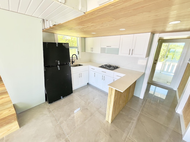 kitchen featuring sink, black appliances, wooden ceiling, and white cabinets