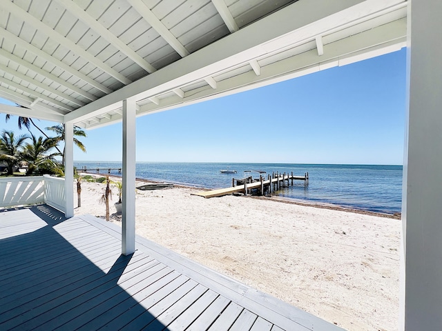 dock area featuring a view of the beach and a deck with water view