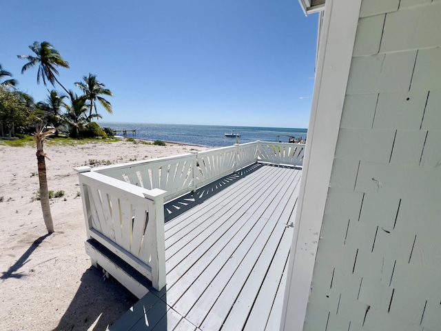 wooden terrace featuring a water view