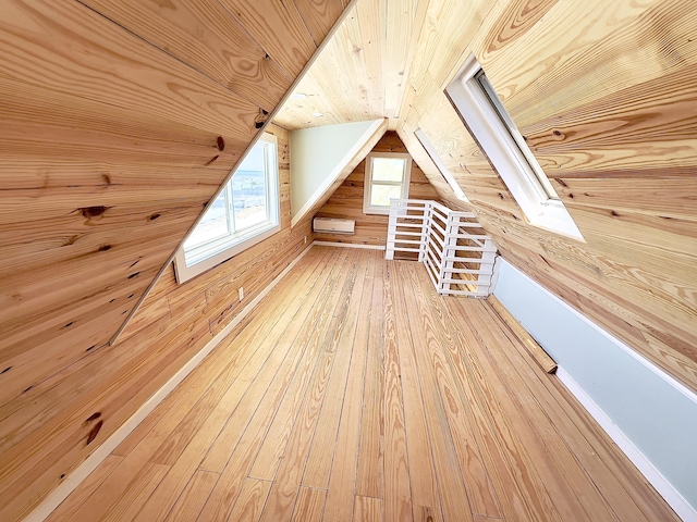 bonus room with hardwood / wood-style flooring, wood ceiling, wooden walls, and vaulted ceiling