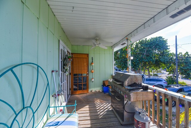 wooden terrace featuring ceiling fan