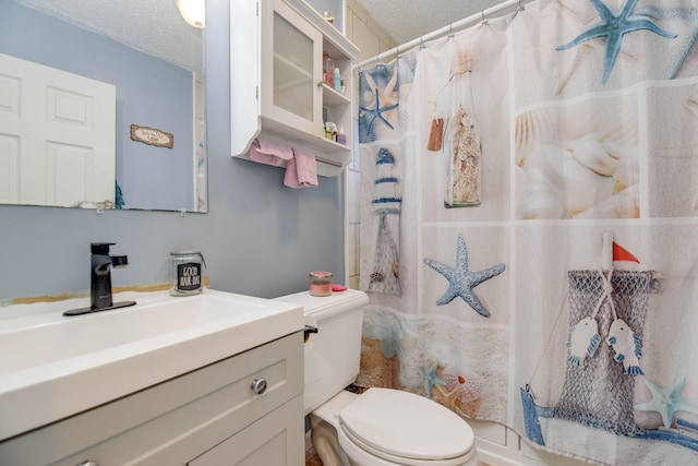 bathroom with vanity, a shower with shower curtain, a textured ceiling, and toilet