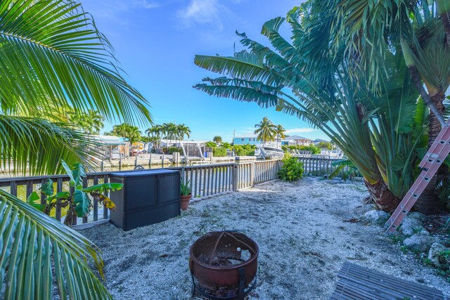 view of patio with a water view and a fire pit