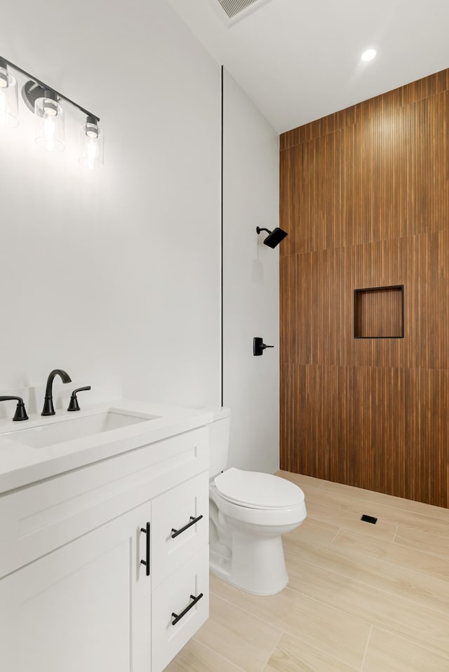 bathroom featuring toilet and vanity