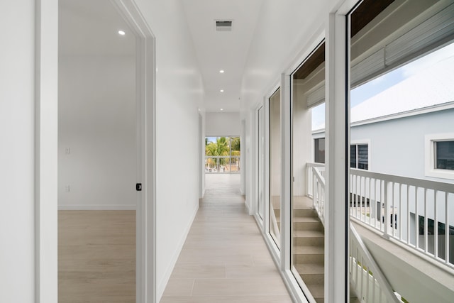 hallway featuring recessed lighting and baseboards