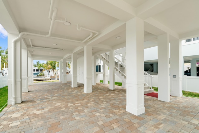 view of patio with stairway and fence