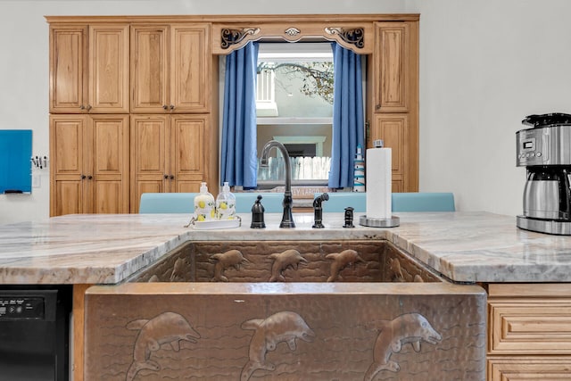 kitchen featuring a sink, light stone countertops, and dishwasher