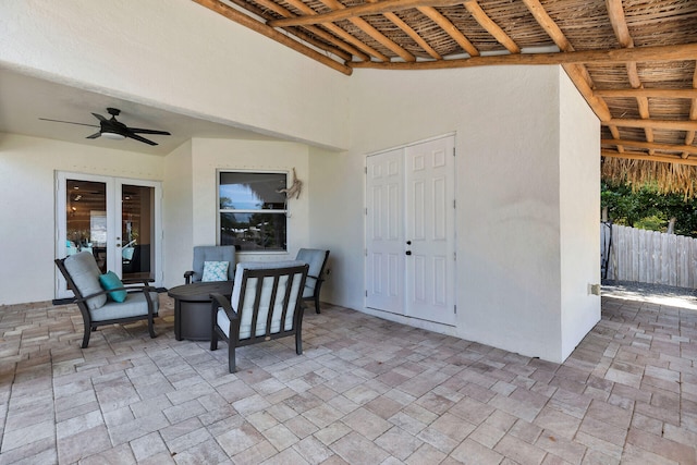 view of patio / terrace with fence and a ceiling fan