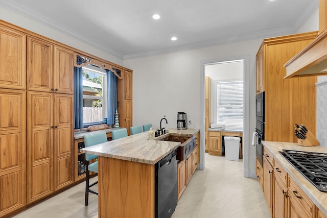 kitchen featuring a kitchen breakfast bar, light stone countertops, crown molding, black appliances, and a sink