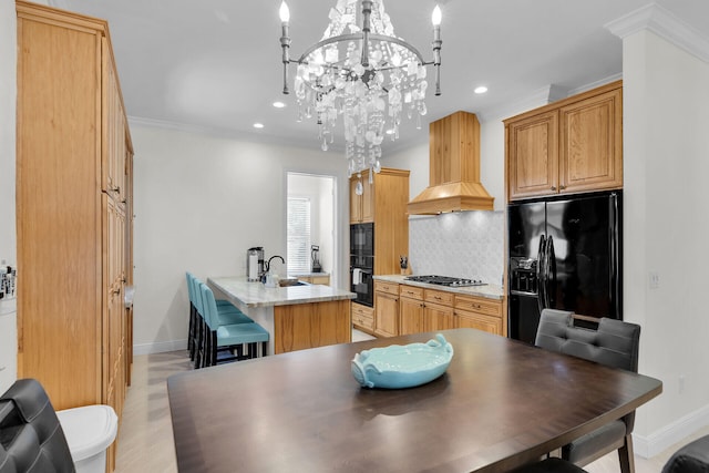 kitchen featuring a sink, ornamental molding, custom exhaust hood, black appliances, and tasteful backsplash