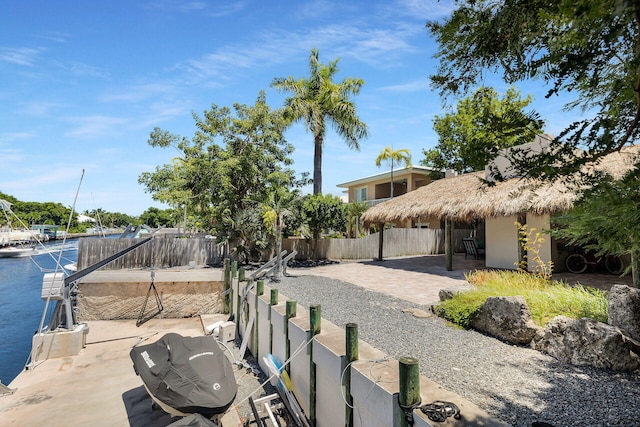 view of yard with a patio area, a water view, and fence