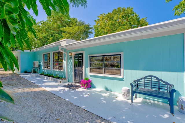 doorway to property with a patio area