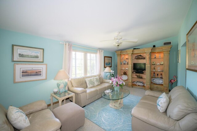 carpeted living room featuring lofted ceiling and ceiling fan