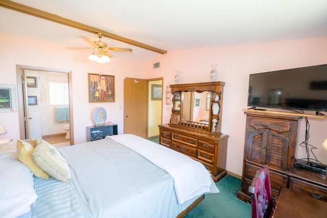 carpeted bedroom featuring ensuite bath