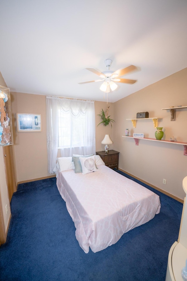 carpeted bedroom featuring vaulted ceiling and ceiling fan