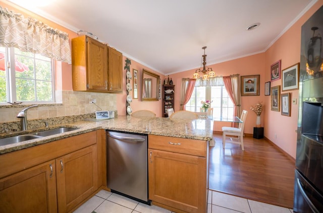 kitchen featuring dishwasher, sink, ornamental molding, and kitchen peninsula