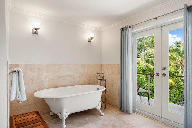 bathroom featuring ornamental molding, a tub to relax in, tile walls, and french doors