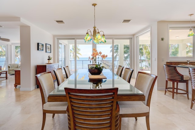 dining area featuring plenty of natural light and a notable chandelier