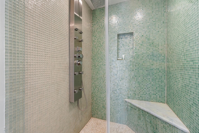 bathroom with tiled shower