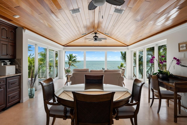 dining area with ornamental molding, vaulted ceiling, wooden ceiling, and a water view