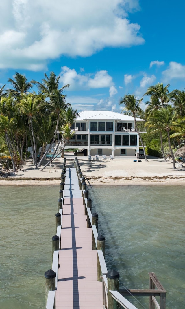 exterior space with a water view and a view of the beach