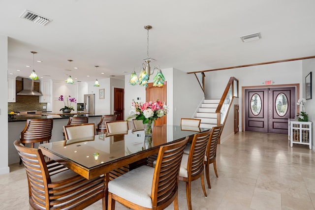 dining space with an inviting chandelier