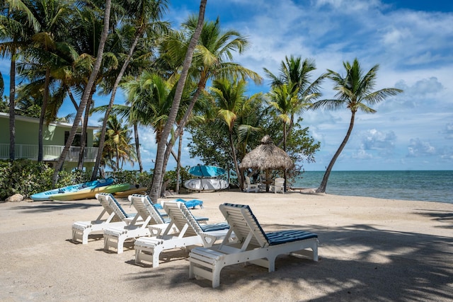 exterior space featuring a gazebo, a water view, and a view of the beach