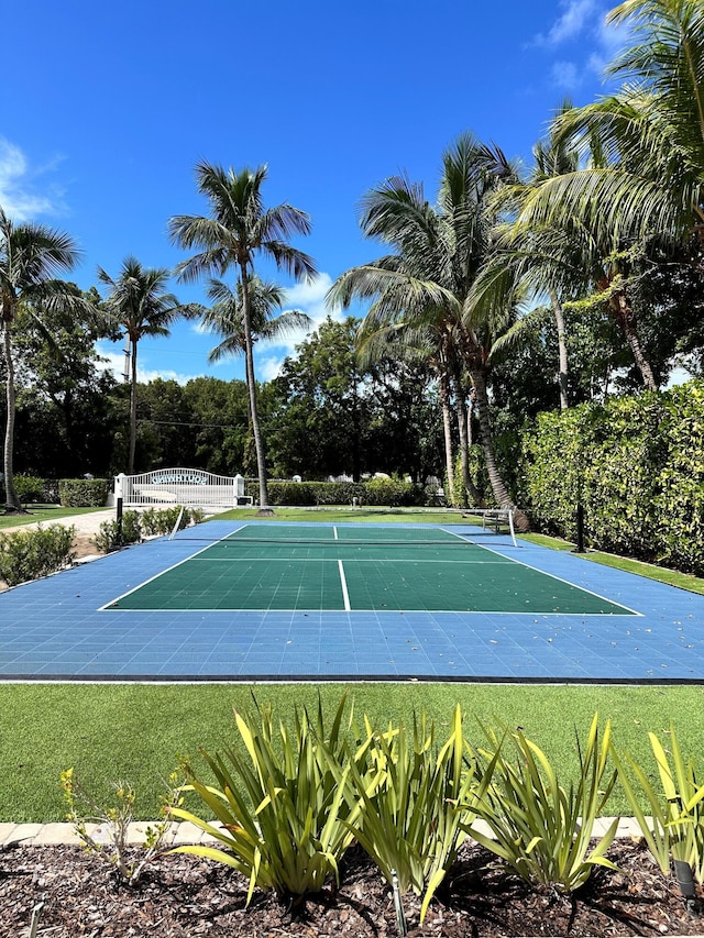 view of tennis court featuring a covered pool