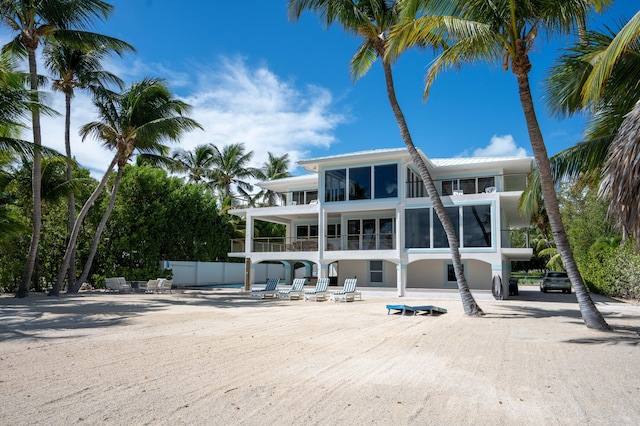 rear view of house featuring a balcony and a patio