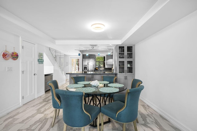 dining room featuring a raised ceiling