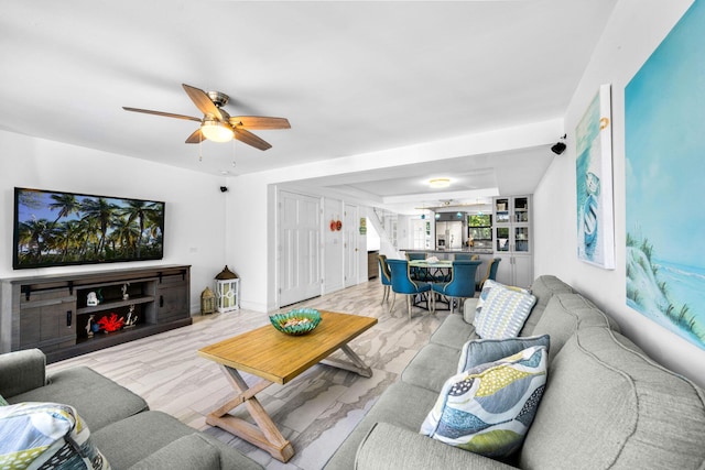 living room featuring light hardwood / wood-style flooring and ceiling fan