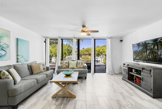 living room featuring expansive windows, ceiling fan, and plenty of natural light