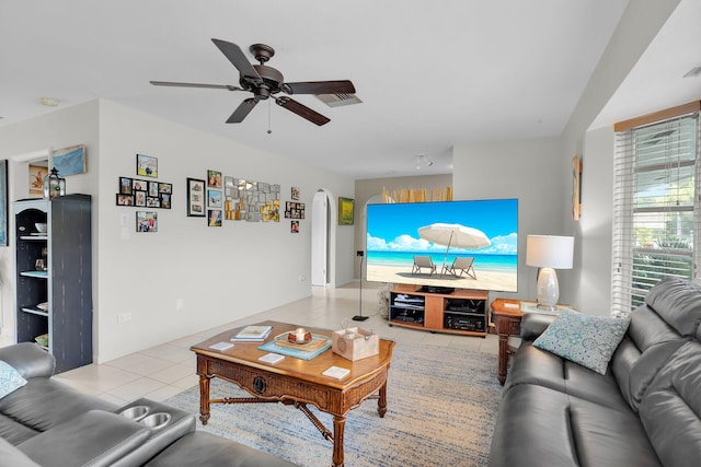 tiled living room with ceiling fan