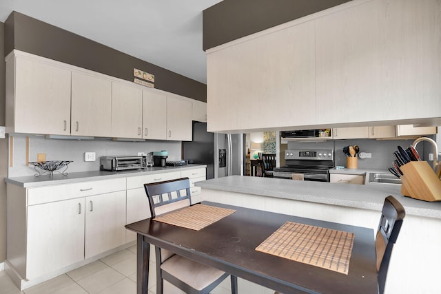 kitchen featuring sink, extractor fan, light tile patterned floors, stainless steel appliances, and backsplash