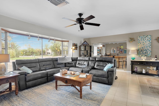 living room featuring light tile patterned floors and ceiling fan