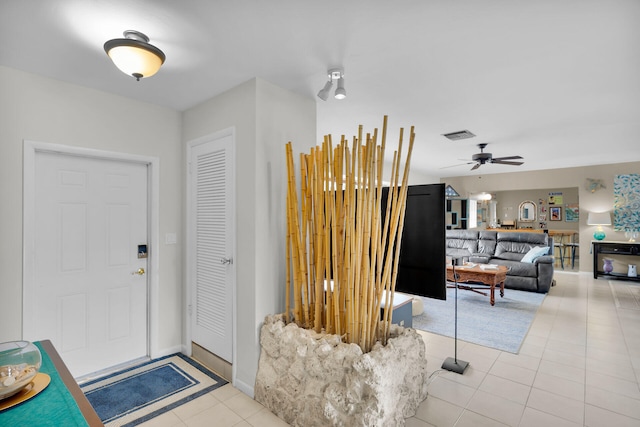 entryway with light tile patterned flooring and ceiling fan