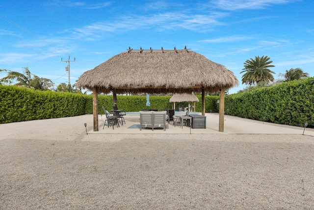 view of community featuring a gazebo, outdoor lounge area, and a patio