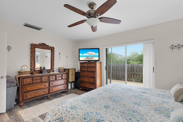 bedroom with ceiling fan, access to exterior, and hardwood / wood-style floors